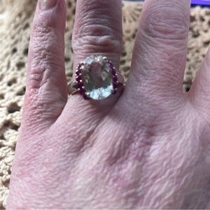 Sterling silver (925) ring with a clear stone and dark pinkish red stones